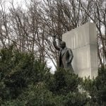 Theodore Roosevelt statue through some bushes