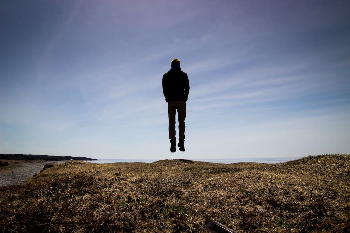 Man levitating in a field