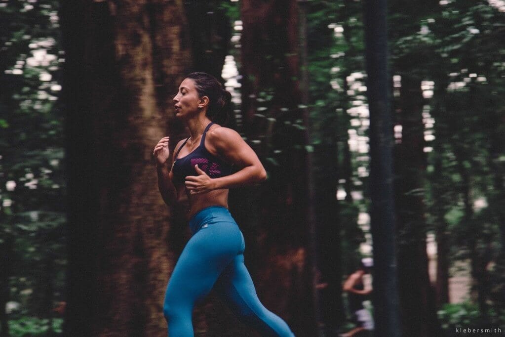 Woman running through a forest