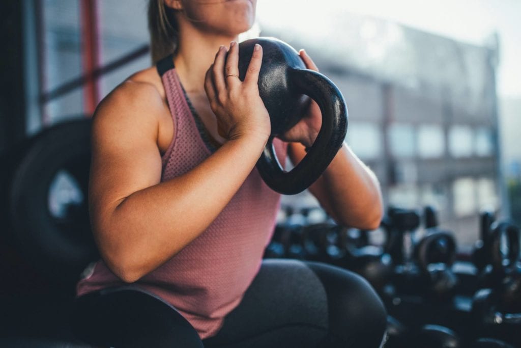 Woman doing a goblet squat with a kettlebell